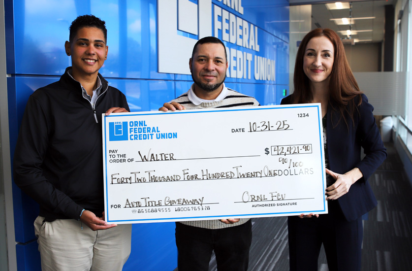 ORNL Team members posing with auto title giveaway winner