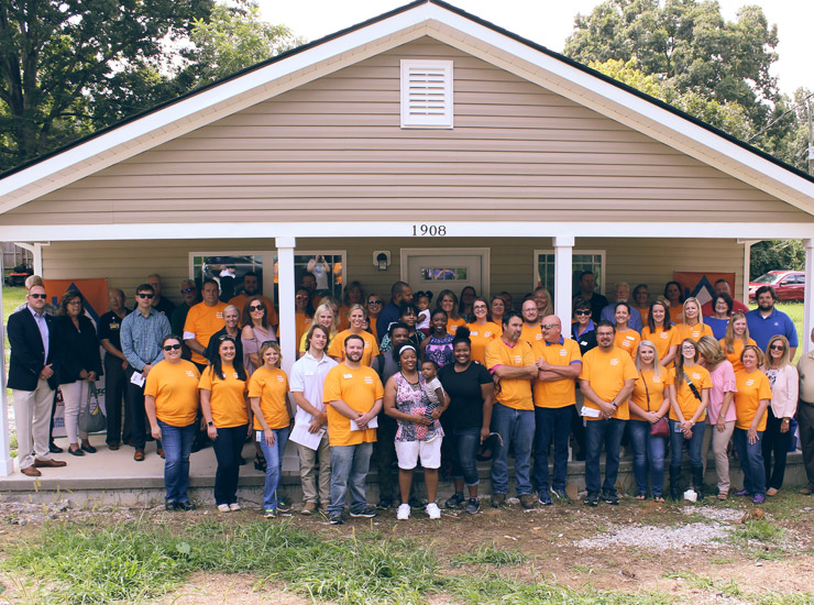 ORNL Team members standing in front of newly renovated house
